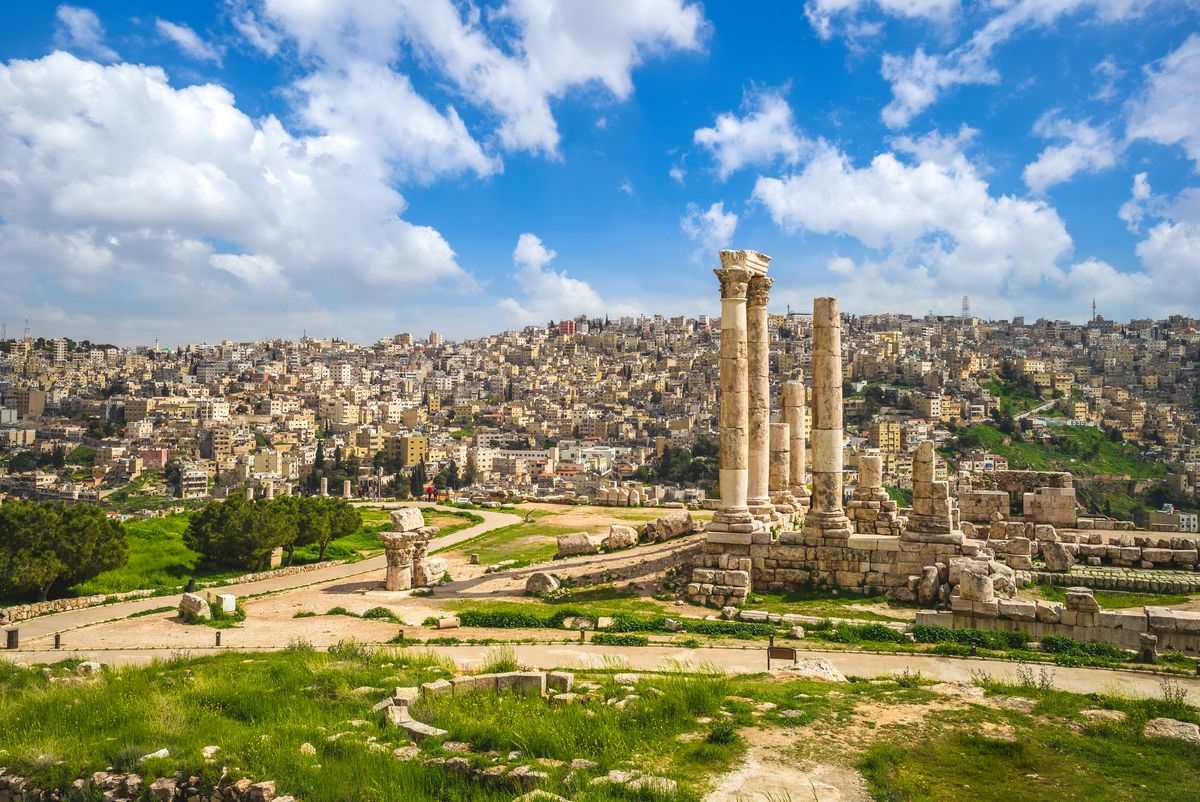 Ancient ruins with tall columns. Skyline of the city of Amman Jordan