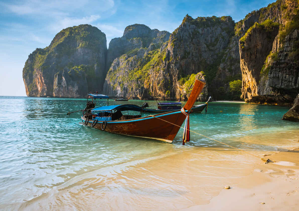 Sunrise on Phi Phi island with a longtail boat