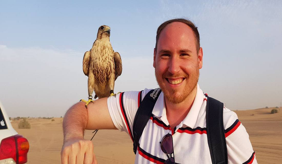 Smiling man with a perched falcon in Dubai