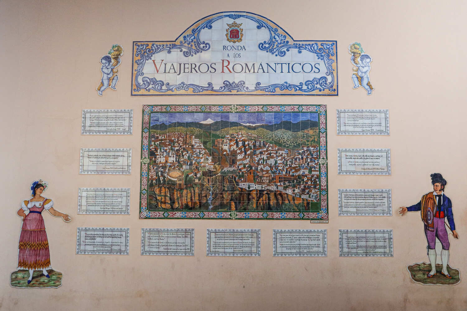 A detailed ceramic plaque depicting historical figures with the title "Viajeros Romanticos" on a wall.